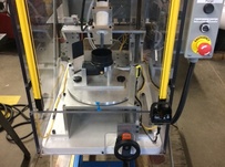 Automated machine to apply a precise bead of silicone to a elbow before assembly
